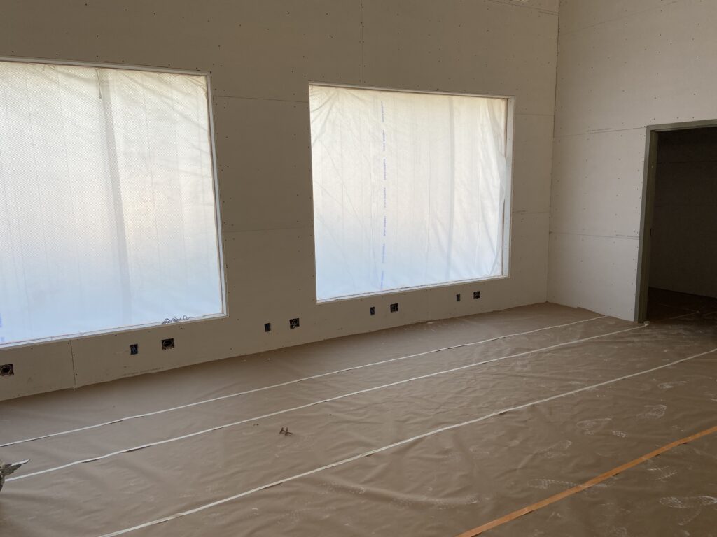 A room that is being remodeled with white tarps.