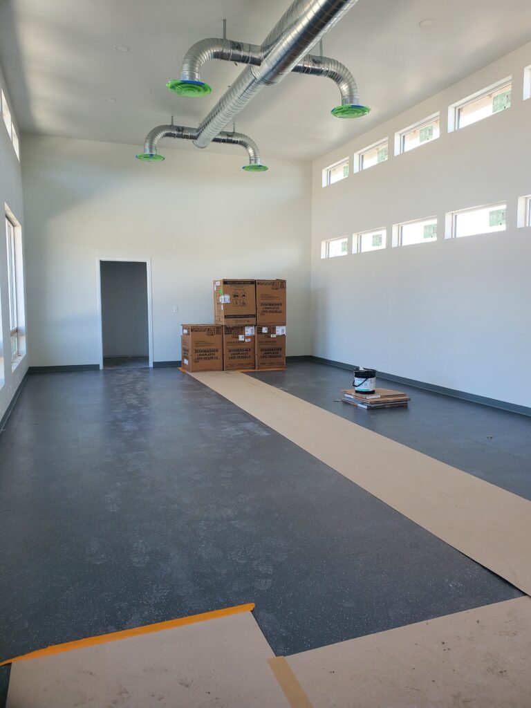 An empty room with a lot of boxes on the floor.