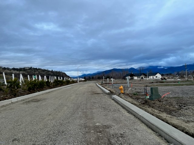 An empty road with mountains in the background.