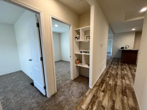 A room with hardwood floors and a closet.