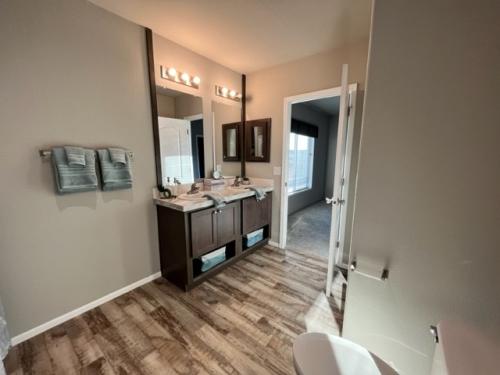 A bathroom with wood floors and a sink.